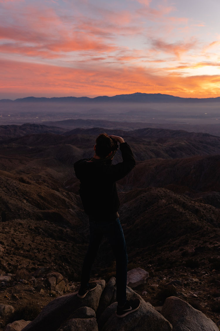 Man photographing sunset in Joshua Tree National Park